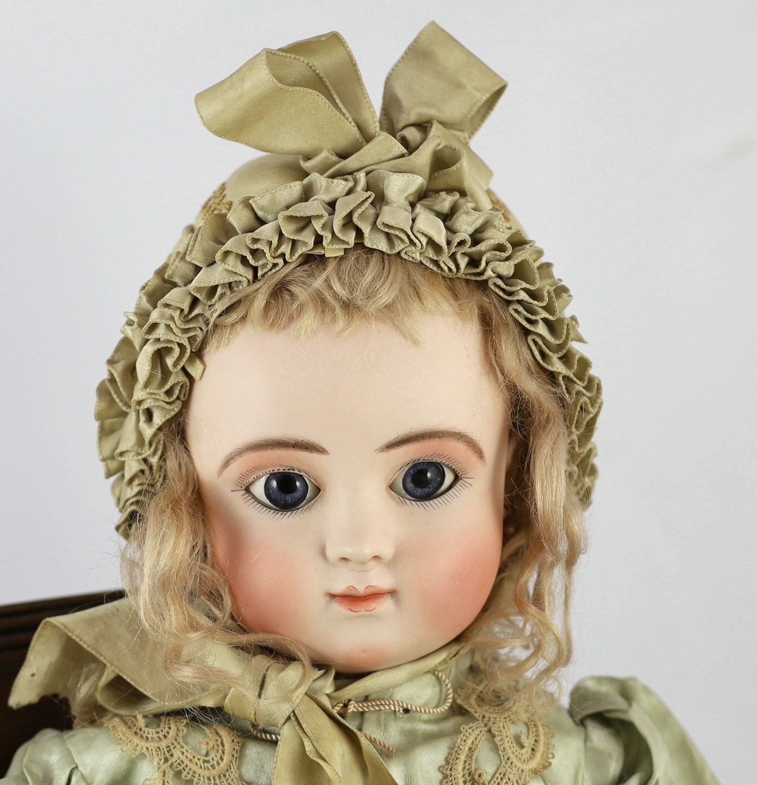 A Jules Steiner Bourgoin bisque doll, French, circa 1880, 24in. Please note the chair is for display purposes only.